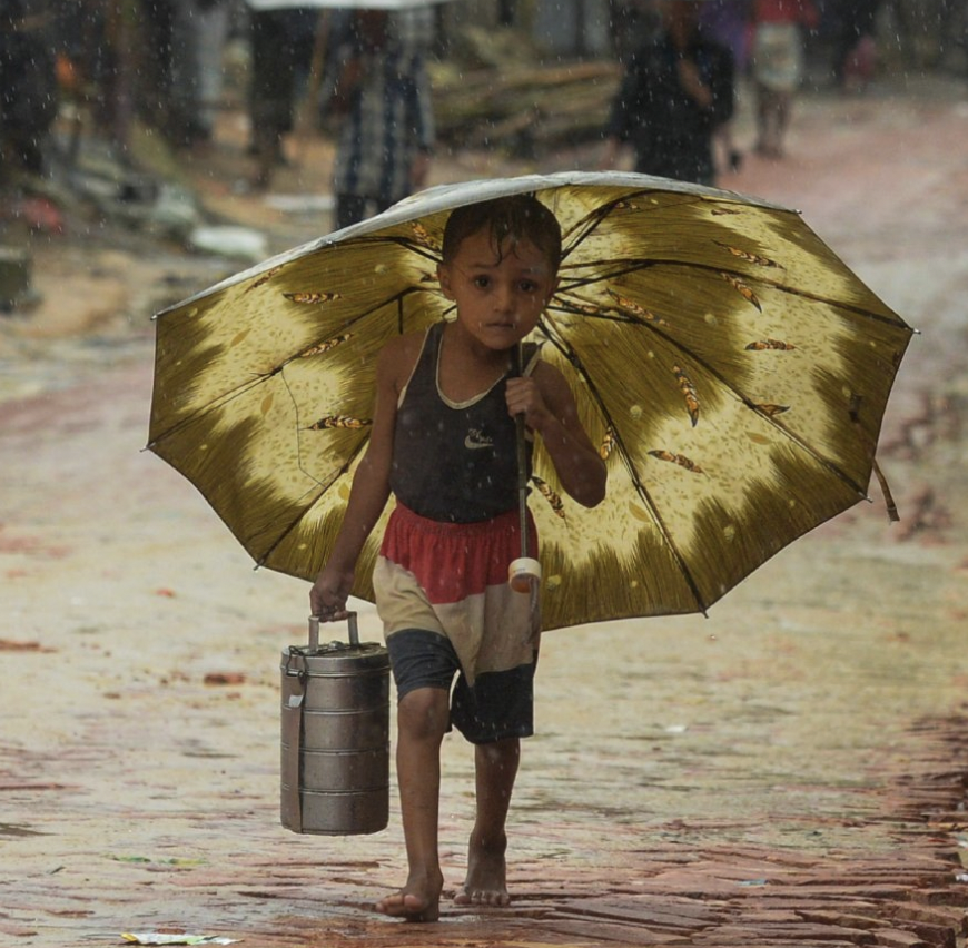 image of refugee child with umbrella